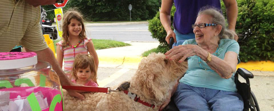 Special needs senior playing with a dog.